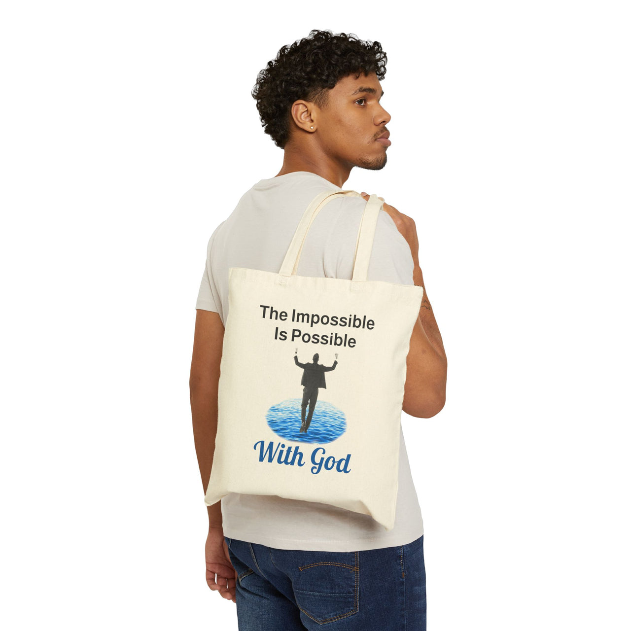 Cotton canvas tote bag with "Impossible Man" design, message “The Impossible Is Possible with God,” printed on both sides, durable spiritual tote bag for men walking in faith, man carrying natural tote bag