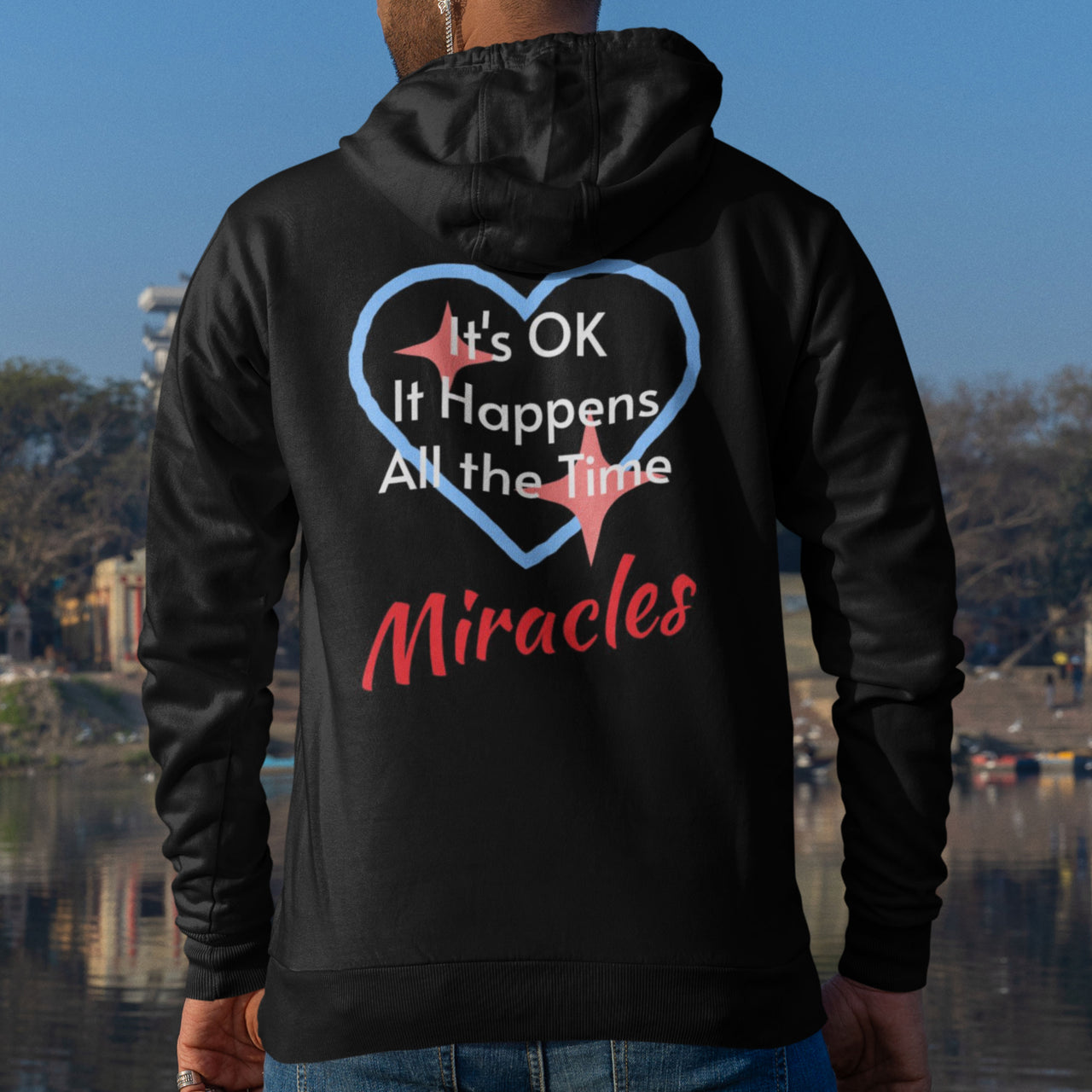 Gildan unisex zip-up hoodie with “Miracles Happen” design and uplifting message, Christian apparel made from soft cotton-poly fleece, ideal for cooler weather and faith-inspired comfort, man wearing black hoodie