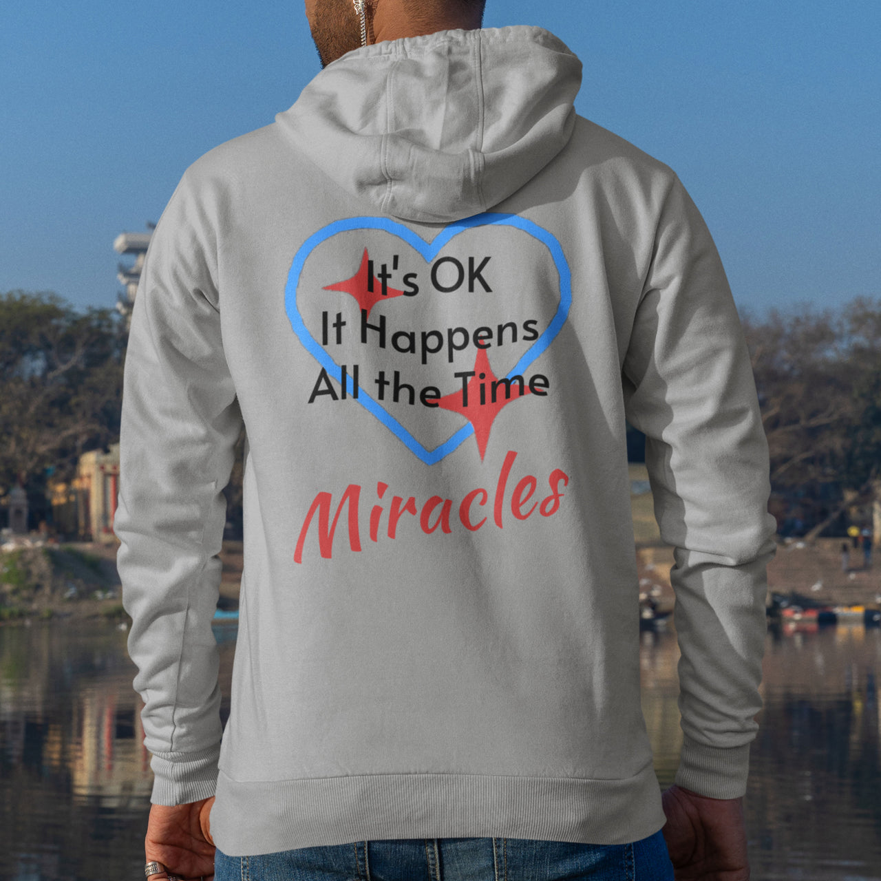 Gildan unisex zip-up hoodie with “Miracles Happen” design and uplifting message, Christian apparel made from soft cotton-poly fleece, ideal for cooler weather and faith-inspired comfort, man wearing gray hoodie