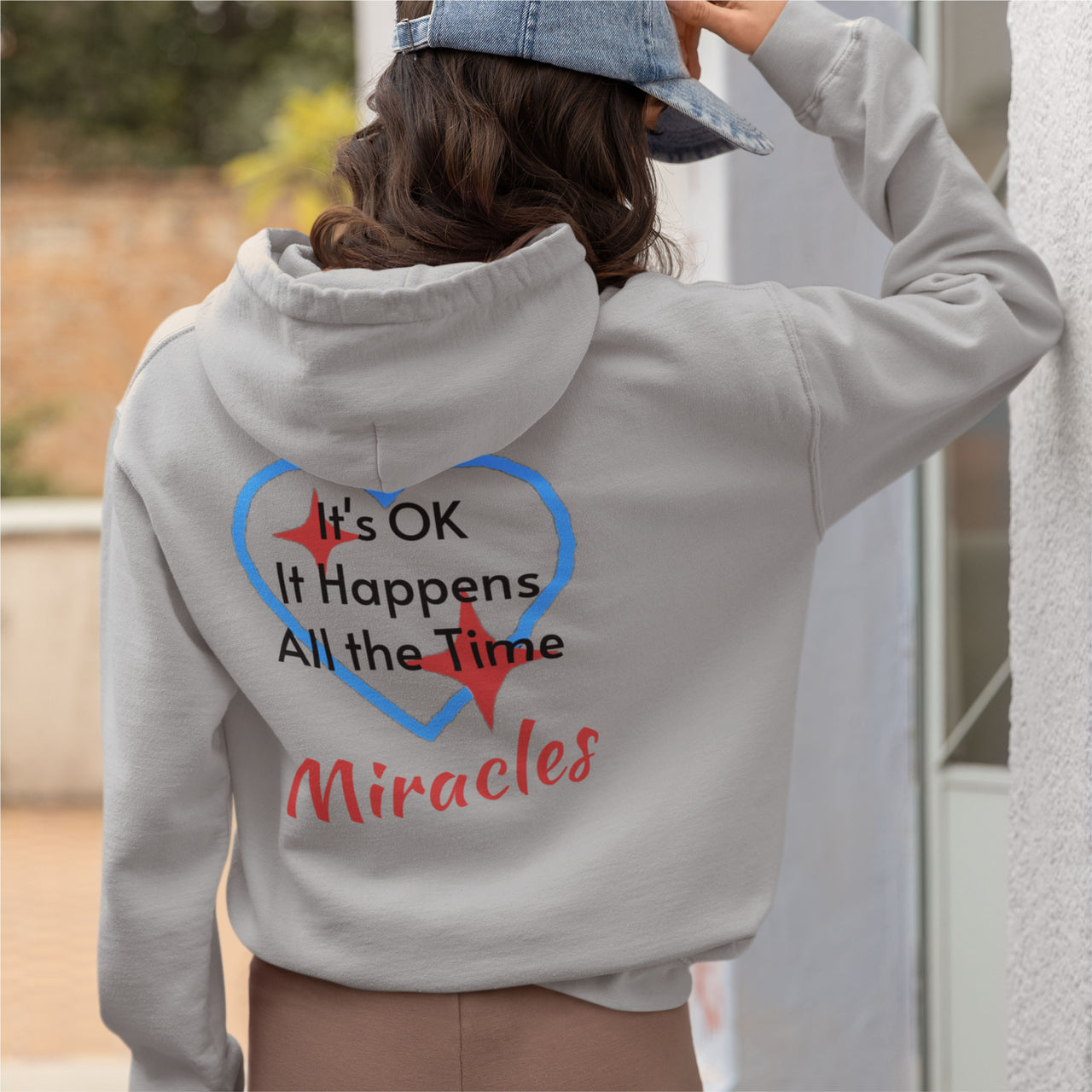 Gildan unisex zip-up hoodie with “Miracles Happen” design and uplifting message, Christian apparel made from soft cotton-poly fleece, ideal for cooler weather and faith-inspired comfort, woman wearing gray hoodie