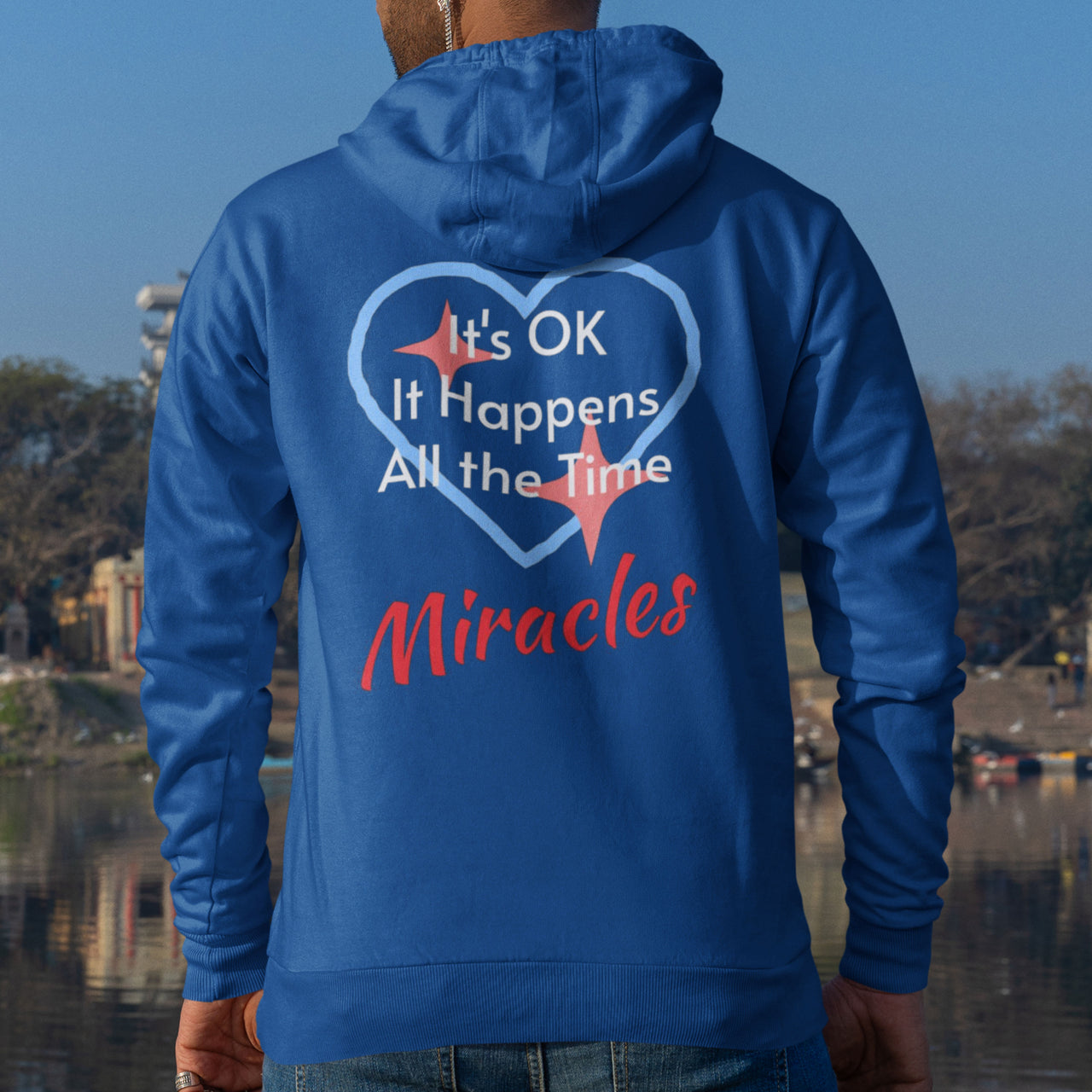 Gildan unisex zip-up hoodie with “Miracles Happen” design and uplifting message, Christian apparel made from soft cotton-poly fleece, ideal for cooler weather and faith-inspired comfort, man wearing blue hoodie