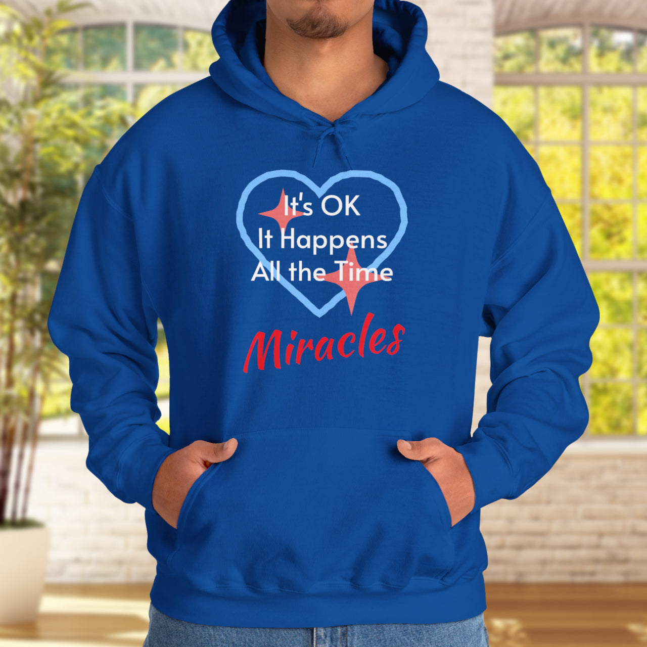 Gildan unisex hoodie with “Miracles Happen” design and uplifting message, Christian apparel made from soft cotton-poly blend, ideal for cooler weather and faith-inspired comfort, man in blue hoodie