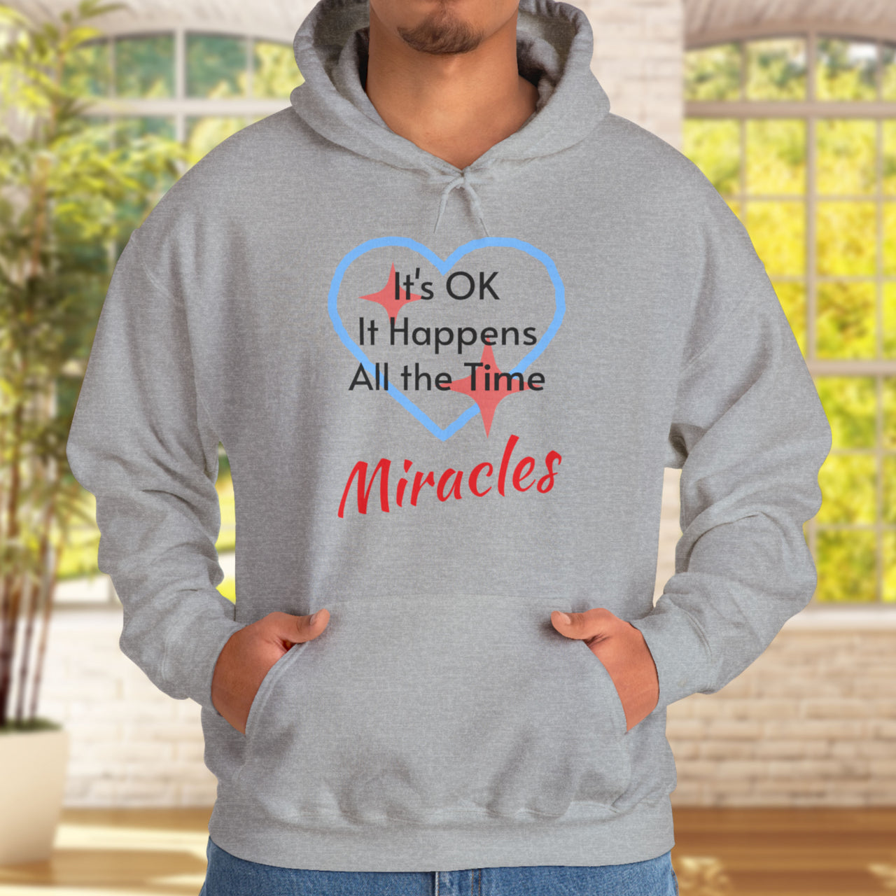 Gildan unisex hoodie with “Miracles Happen” design and uplifting message, Christian apparel made from soft cotton-poly blend, ideal for cooler weather and faith-inspired comfort, man in gray hoodie