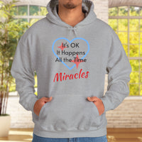 Gildan unisex hoodie with “Miracles Happen” design and uplifting message, Christian apparel made from soft cotton-poly blend, ideal for cooler weather and faith-inspired comfort, man in gray hoodie