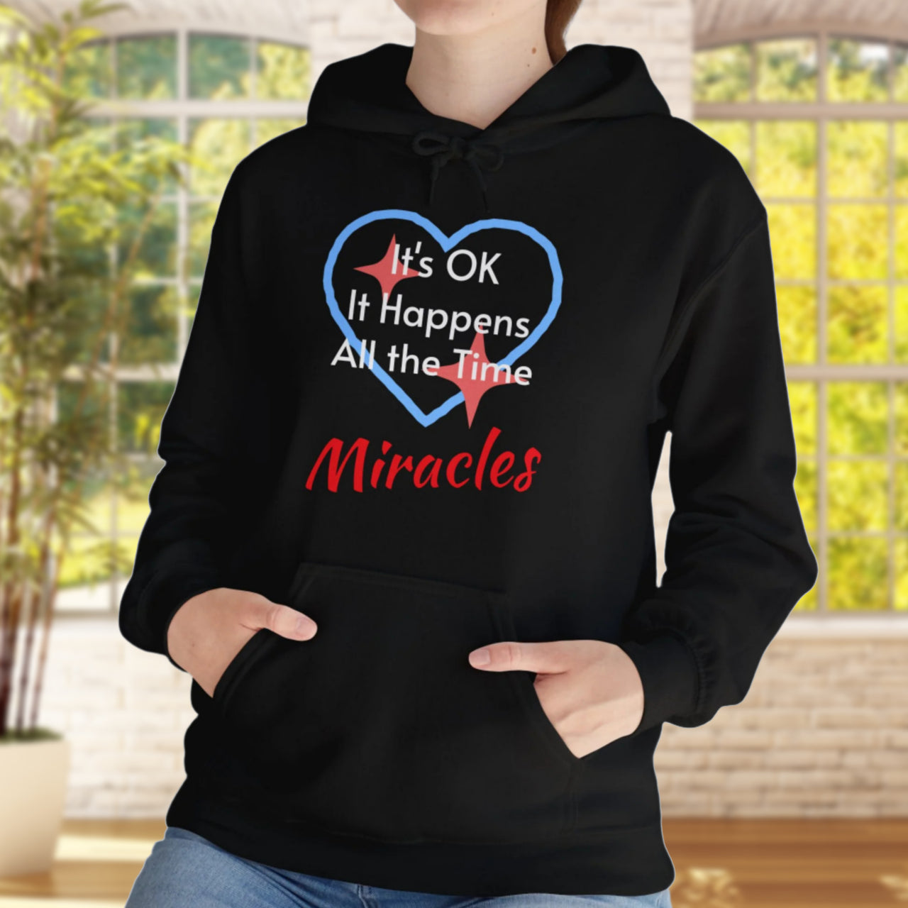 Gildan unisex hoodie with “Miracles Happen” design and uplifting message, Christian apparel made from soft cotton-poly blend, ideal for cooler weather and faith-inspired comfort, black hoodie