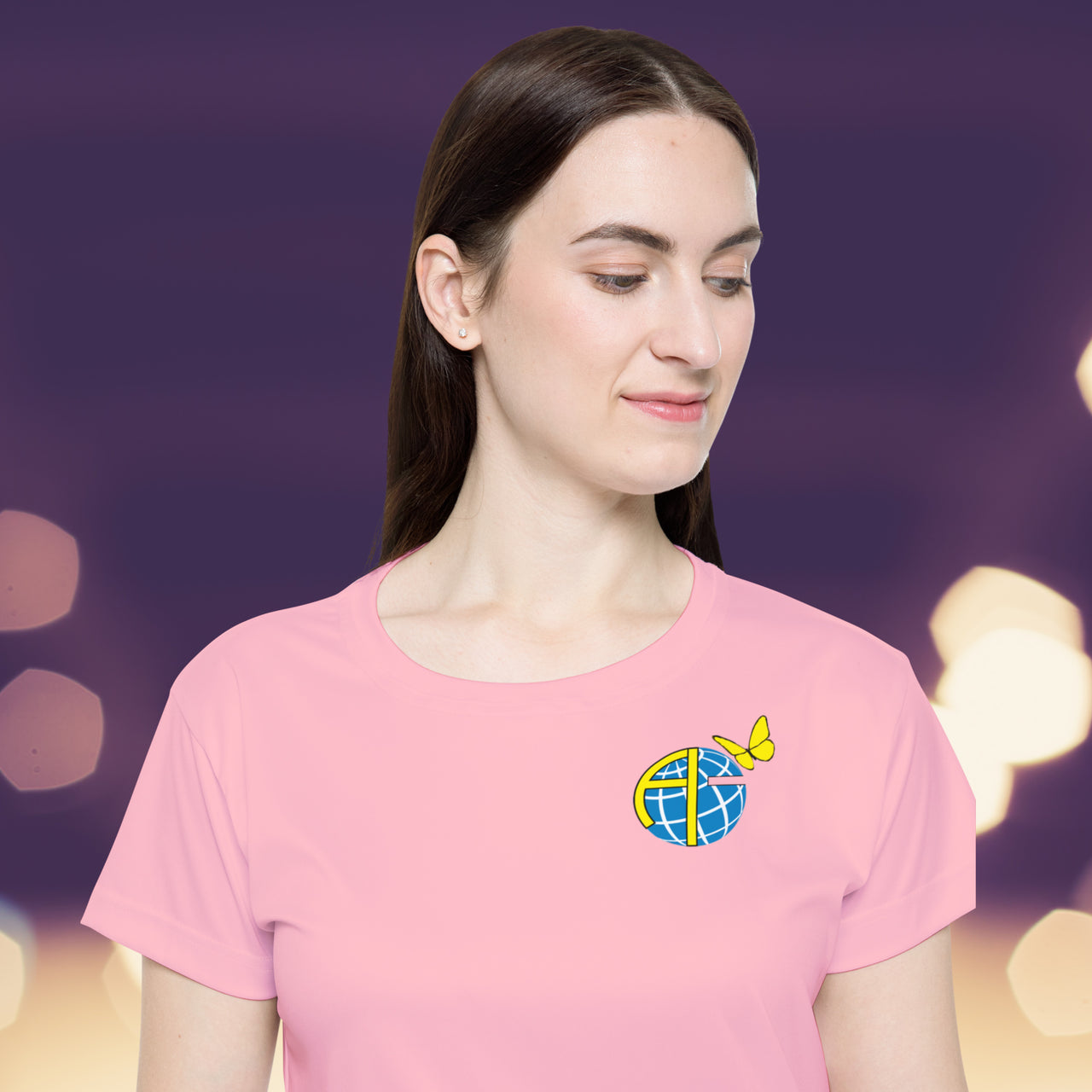 Women’s sport jersey with Anakainoo International logo, breathable moisture-wicking fabric with globe and butterfly design symbolizing spiritual transformation and renewal through intimacy with God, close-up of logo on pink sports jersey