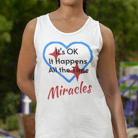 Lightweight Bella+Canvas tank top made from preshrunk cotton with “Miracles Happen” design message, “It’s OK. It Happens All the Time – Miracles,” inspirational apparel encouraging daily miracles through intimacy with God, woman wearing white tank top