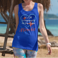 Lightweight Bella+Canvas tank top made from preshrunk cotton with “Miracles Happen” design message, “It’s OK. It Happens All the Time – Miracles,” inspirational apparel encouraging daily miracles through intimacy with God, 2nd woman at beach wearing blue tank top