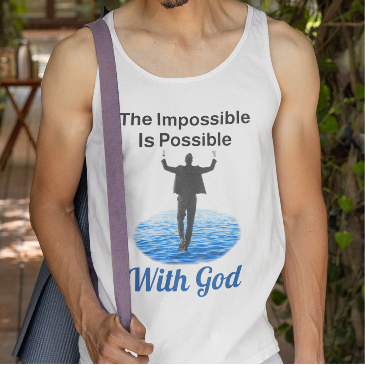Lightweight Bella+Canvas tank top made from preshrunk cotton with “Impossible Man” design message, “The Impossible Is Possible with God,” inspirational apparel calling believers to step out in faith and walk with God into new possibilities, man in white tank top