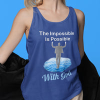 Lightweight Bella+Canvas tank top made from preshrunk cotton with “Impossible Man” design message, “The Impossible Is Possible with God,” inspirational apparel calling believers to step out in faith and walk with God into new possibilities, woman wearing blue tank top