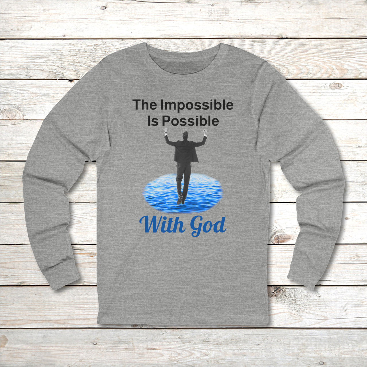 Long-sleeve Bella+Canvas t-shirt made from preshrunk ring-spun cotton with “Impossible Man” design message, “The Impossible Is Possible with God,” inspirational apparel calling believers to step out in faith and trust God for more than they can ask or imagine, front gray long-sleeve t-shirt