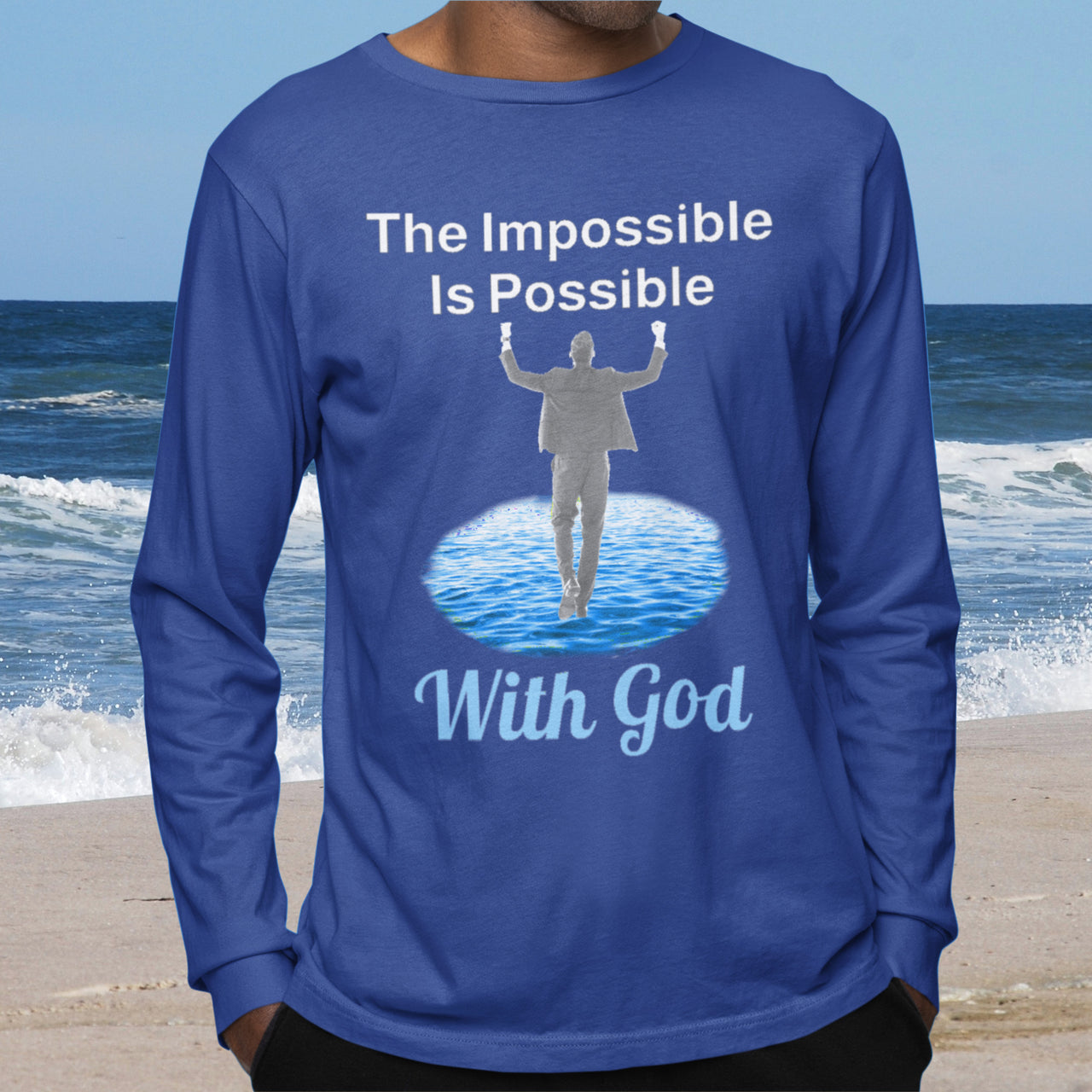 Long-sleeve Bella+Canvas t-shirt made from preshrunk ring-spun cotton with “Impossible Man” design message, “The Impossible Is Possible with God,” inspirational apparel calling believers to step out in faith and trust God for more than they can ask or imagine, man wearing blue long-sleeve t-shirt