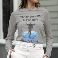 Long-sleeve Bella+Canvas t-shirt made from preshrunk ring-spun cotton with “Impossible Man” design message, “The Impossible Is Possible with God,” inspirational apparel calling believers to step out in faith and trust God for more than they can ask or imagine, woman in gray t-shirt