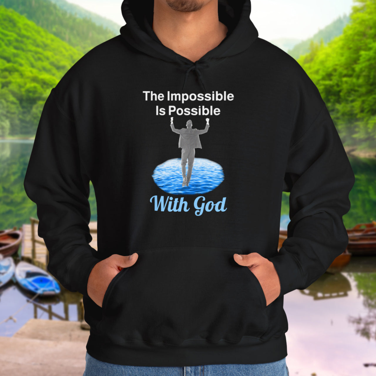 Gildan unisex hoodie with “Impossible Man” design featuring a man walking on water and uplifting message, Christian apparel made from soft cotton-poly blend, perfect for cold weather and spiritual encouragement, man in black hoodie
