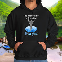 Gildan unisex hoodie with “Impossible Man” design featuring a man walking on water and uplifting message, Christian apparel made from soft cotton-poly blend, perfect for cold weather and spiritual encouragement, man in black hoodie
