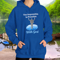 Gildan unisex hoodie with “Impossible Man” design featuring a man walking on water and uplifting message, Christian apparel made from soft cotton-poly blend, perfect for cold weather and spiritual encouragement, woman in blue hoodie