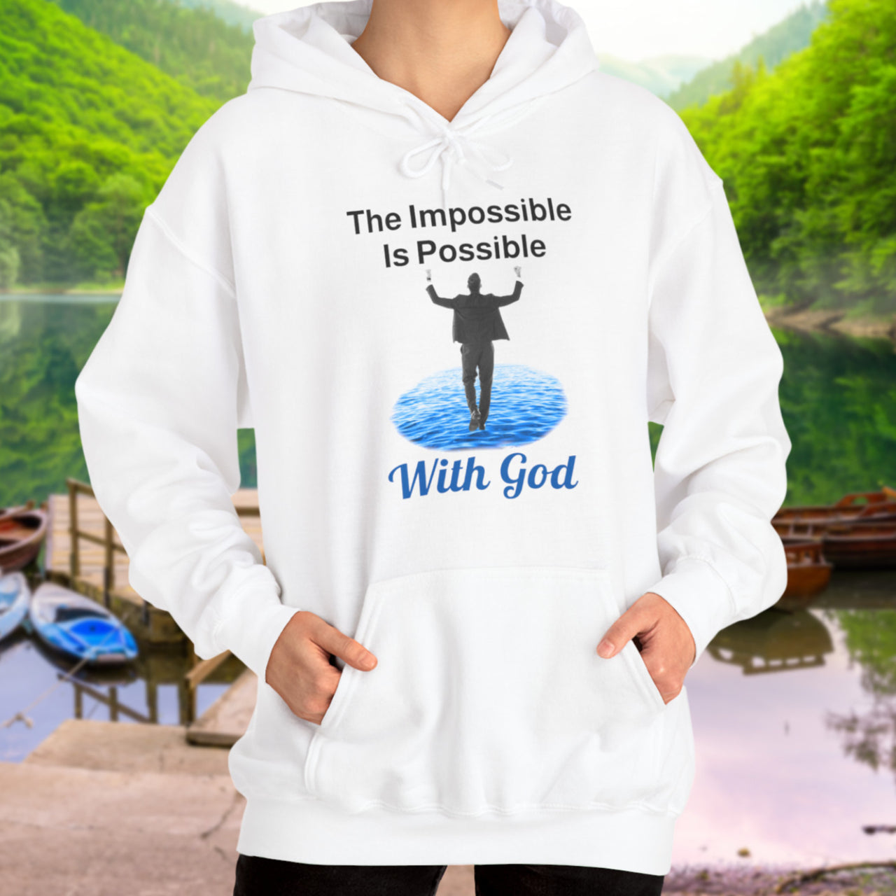 Gildan unisex hoodie with “Impossible Man” design featuring a man walking on water and uplifting message, Christian apparel made from soft cotton-poly blend, perfect for cold weather and spiritual encouragement, woman in white hoodie