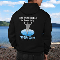 Gildan unisex zip-up hoodie with “Impossible Man” design featuring a man walking on water and uplifting message, Christian apparel made from soft cotton-poly fleece, perfect for cold weather and spiritual encouragement, man in black hoodie