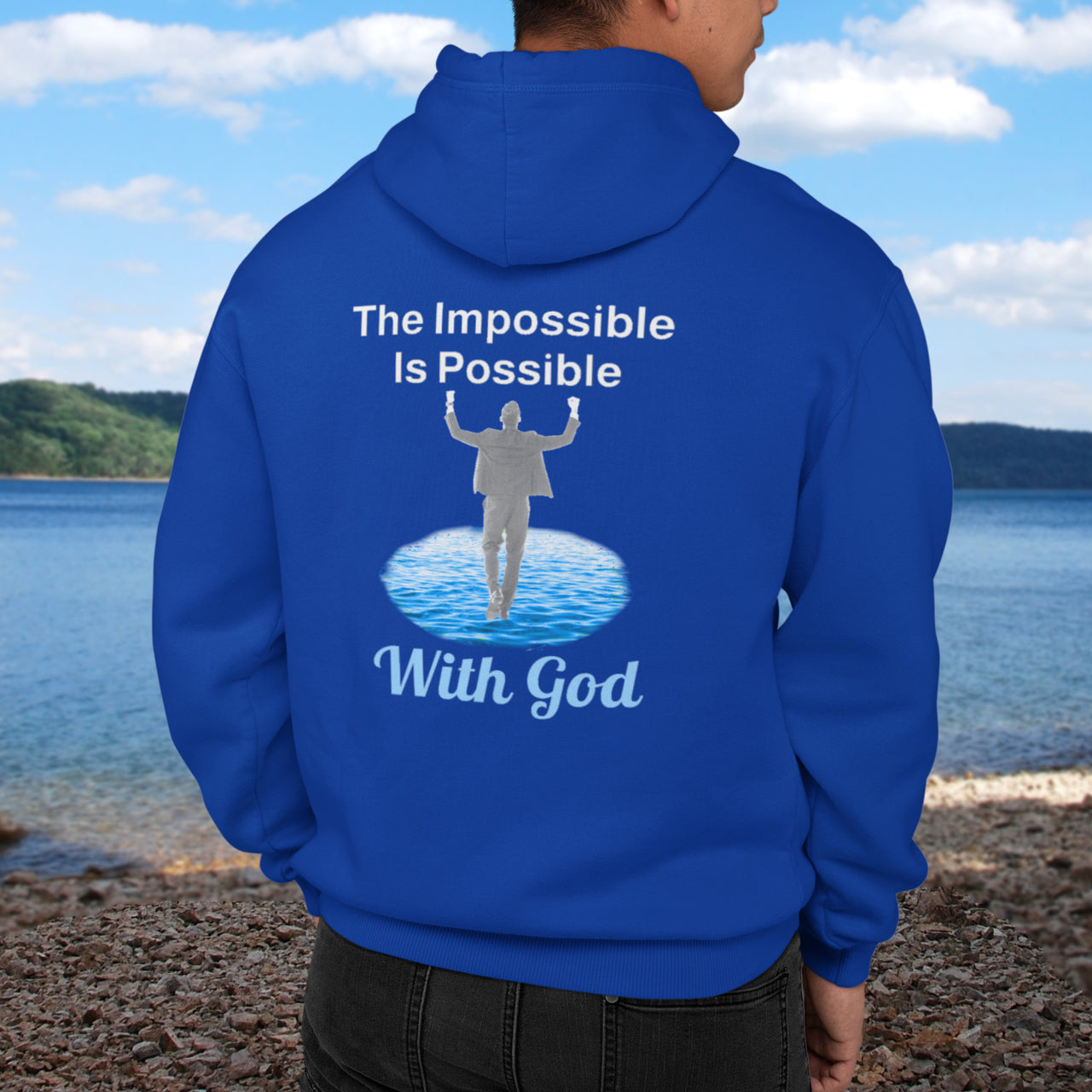 Gildan unisex zip-up hoodie with “Impossible Man” design featuring a man walking on water and uplifting message, Christian apparel made from soft cotton-poly fleece, perfect for cold weather and spiritual encouragement, man in blue hoodie