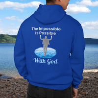 Gildan unisex zip-up hoodie with “Impossible Man” design featuring a man walking on water and uplifting message, Christian apparel made from soft cotton-poly fleece, perfect for cold weather and spiritual encouragement, man in blue hoodie