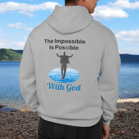 Gildan unisex zip-up hoodie with “Impossible Man” design featuring a man walking on water and uplifting message, Christian apparel made from soft cotton-poly fleece, perfect for cold weather and spiritual encouragement, man in gray hoodie