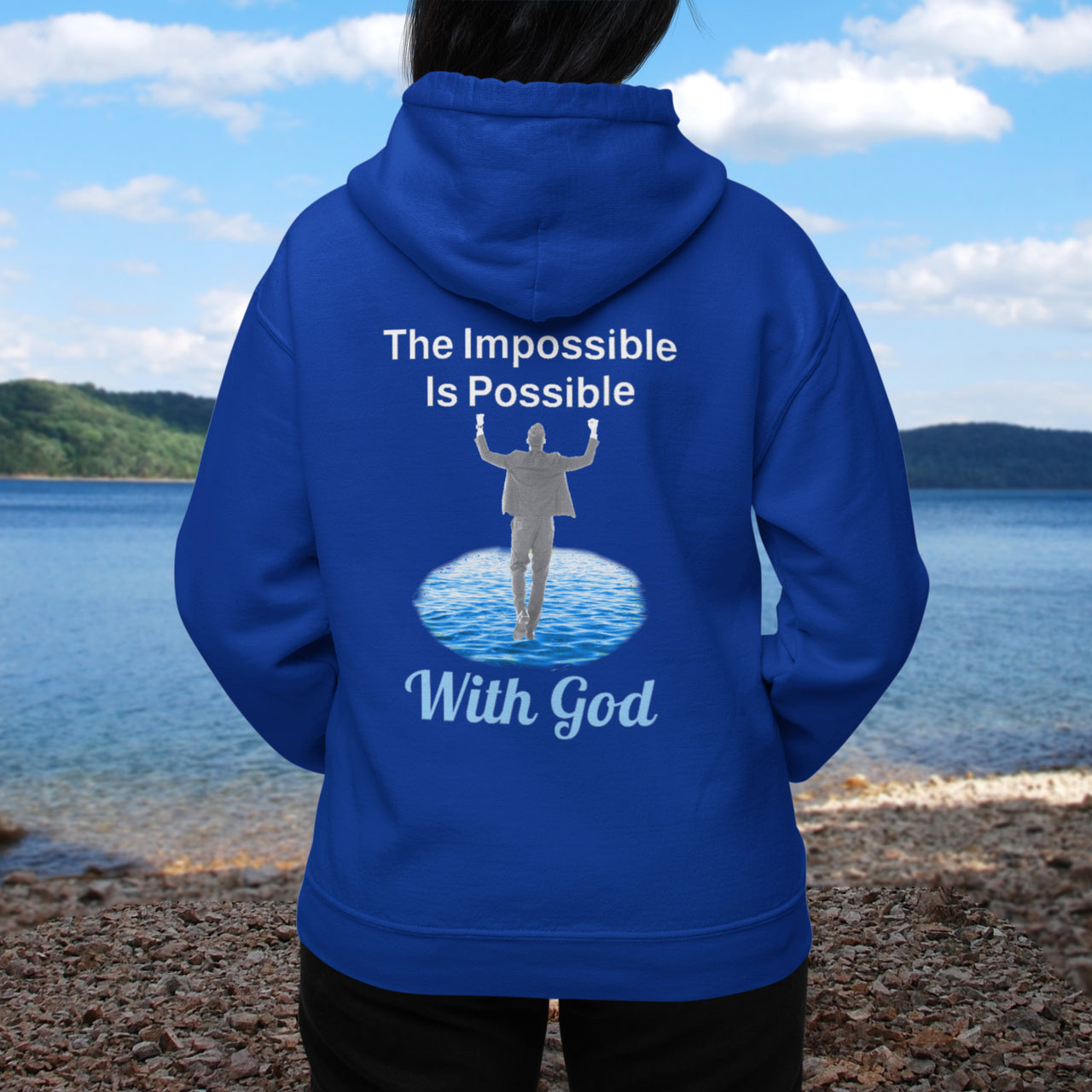 Gildan unisex zip-up hoodie with “Impossible Man” design featuring a man walking on water and uplifting message, Christian apparel made from soft cotton-poly fleece, perfect for cold weather and spiritual encouragement, woman in blue hoodie