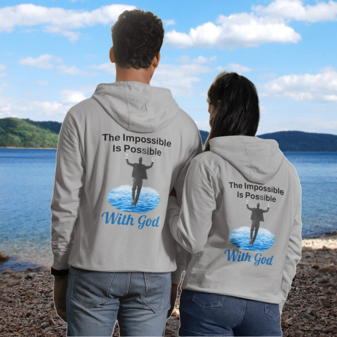 Gildan unisex zip-up hoodie with “Impossible Man” design featuring a man walking on water and uplifting message, Christian apparel made from soft cotton-poly fleece, perfect for cold weather and spiritual encouragement, couple in gray hoodie