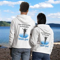 Gildan unisex zip-up hoodie with “Impossible Man” design featuring a man walking on water and uplifting message, Christian apparel made from soft cotton-poly fleece, perfect for cold weather and spiritual encouragement, couple in white hoodie