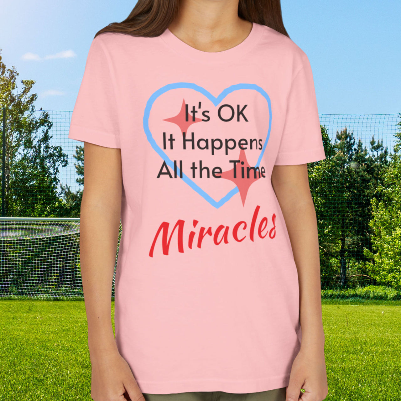 Bella+Canvas youth unisex t-shirt with “Miracles Happen” design and uplifting message, Christian apparel made from soft cotton, ideal for active kids and faith-inspired everyday wear, girl in pink t-shirt
