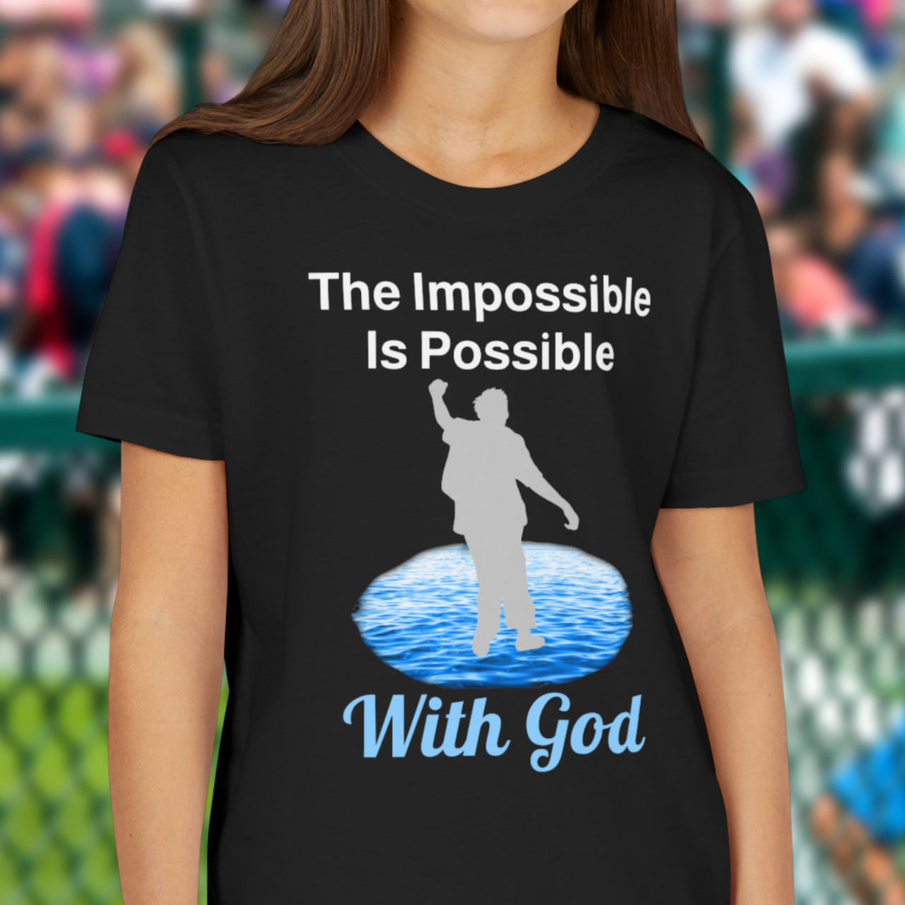 Bella+Canvas youth unisex t-shirt with “Impossible Teen” design featuring a teen walking on water and uplifting message, Christian apparel made from soft cotton, perfect for active wear and spiritual encouragement, girl in black t-shirt