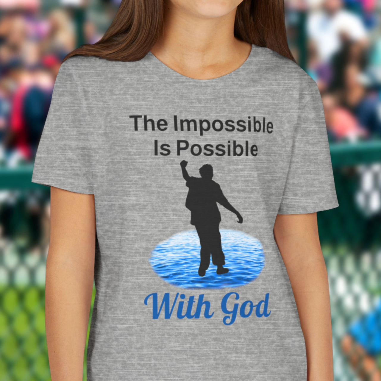 Bella+Canvas youth unisex t-shirt with “Impossible Teen” design featuring a teen walking on water and uplifting message, Christian apparel made from soft cotton, perfect for active wear and spiritual encouragement, girl in gray t-shirt