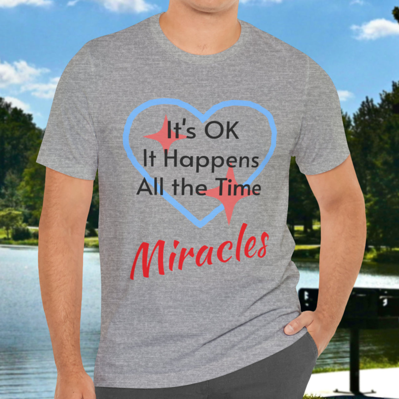 Soft, breathable Bella+Canvas t-shirt made from preshrunk cotton with “Miracles Happen” design message, “It’s OK. It Happens All the Time – Miracles,” inspirational shirt encouraging intimacy with God that produces everyday miracles, man wearing gray t-shirt