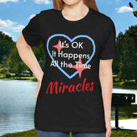 Soft, breathable Bella+Canvas t-shirt made from preshrunk cotton with “Miracles Happen” design message, “It’s OK. It Happens All the Time – Miracles,” inspirational shirt encouraging intimacy with God that produces everyday miracles, woman wearing black t-shirt