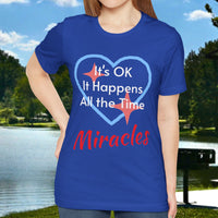 Soft, breathable Bella+Canvas t-shirt made from preshrunk cotton with “Miracles Happen” design message, “It’s OK. It Happens All the Time – Miracles,” inspirational shirt encouraging intimacy with God that produces everyday miracles, woman in blue shirt