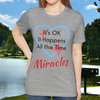 Soft, breathable Bella+Canvas t-shirt made from preshrunk cotton with “Miracles Happen” design message, “It’s OK. It Happens All the Time – Miracles,” inspirational shirt encouraging intimacy with God that produces everyday miracles, woman in gray shirt