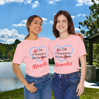 Soft, breathable Bella+Canvas t-shirt made from preshrunk cotton with “Miracles Happen” design message, “It’s OK. It Happens All the Time – Miracles,” inspirational shirt encouraging intimacy with God that produces everyday miracles, friends wearing matching t-shirts