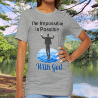 Soft, breathable Bella+Canvas t-shirt made from preshrunk cotton with “Impossible Man” design message, “The Impossible Is Possible with God,” inspirational shirt encouraging bold faith to step out and follow God into the impossible, woman in gray t-shirt