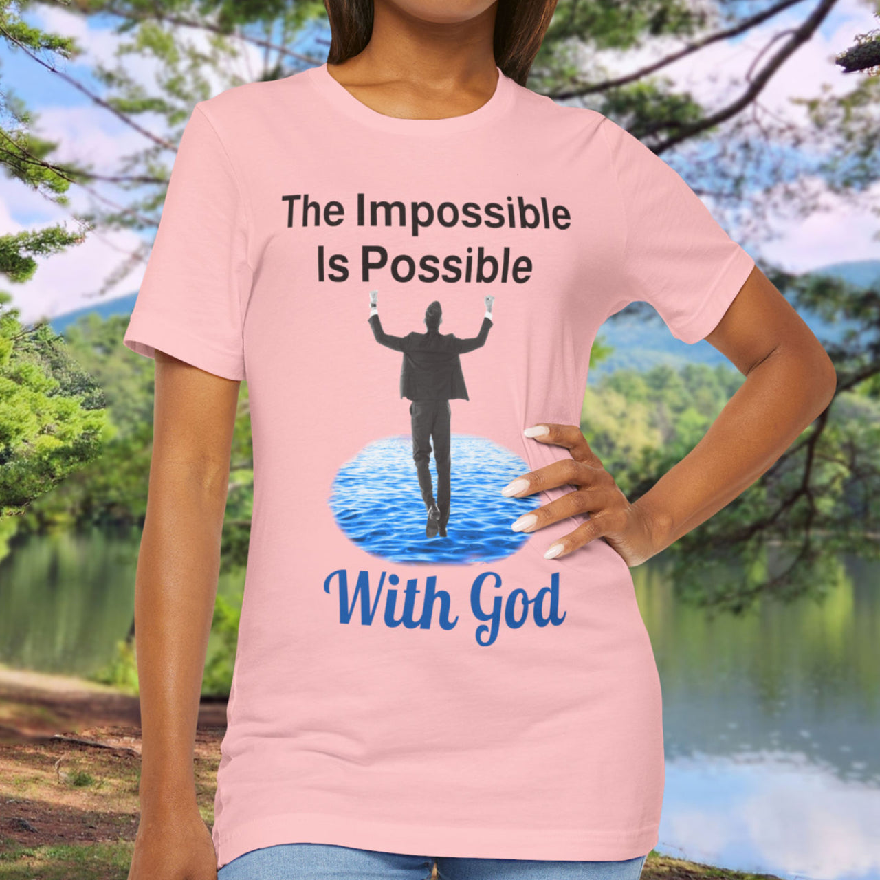 Soft, breathable Bella+Canvas t-shirt made from preshrunk cotton with “Impossible Man” design message, “The Impossible Is Possible with God,” inspirational shirt encouraging bold faith to step out and follow God into the impossible, woman in pink t-shirt