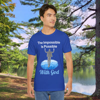 Soft, breathable Bella+Canvas t-shirt made from preshrunk cotton with “Impossible Man” design message, “The Impossible Is Possible with God,” inspirational shirt encouraging bold faith to step out and follow God into the impossible, man in blue t-shirt at park