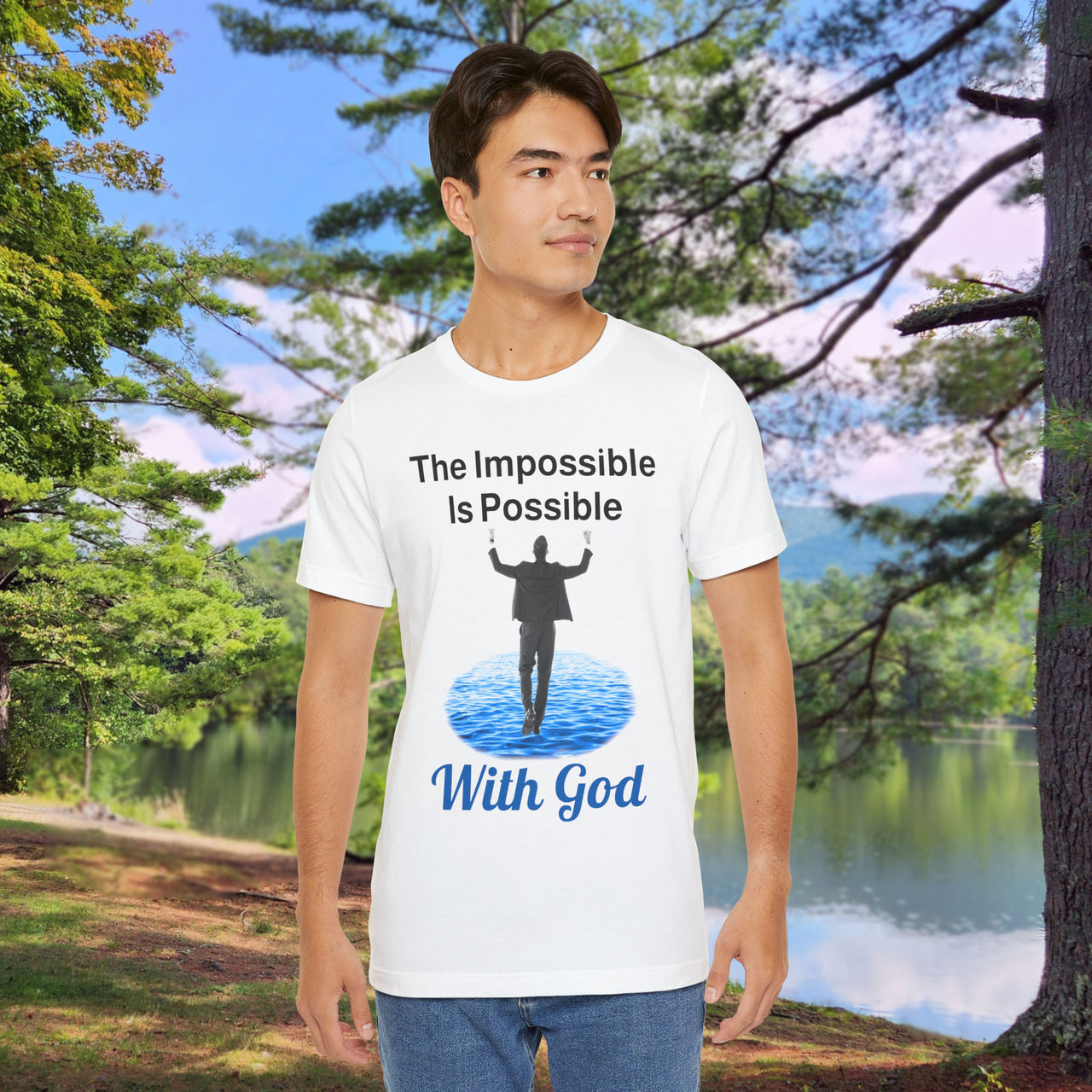 Soft, breathable Bella+Canvas t-shirt made from preshrunk cotton with “Impossible Man” design message, “The Impossible Is Possible With God,” inspirational shirt encouraging bold faith to step out and follow God into the impossible, man in white t-shirt at park