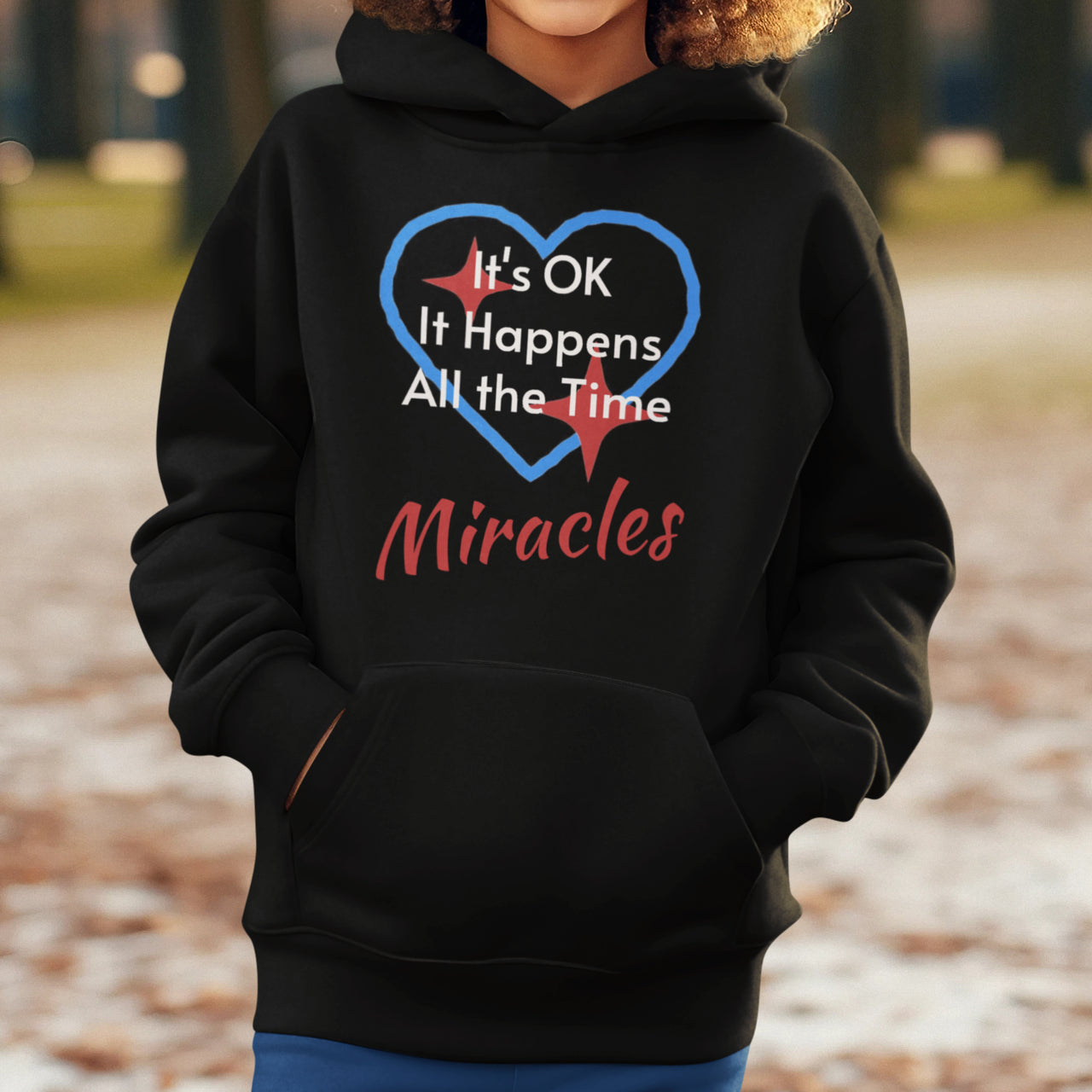 Gildan youth unisex hoodie with “Miracles Happen” design and uplifting message, Christian apparel made from soft preshrunk fleece, ideal for cooler weather and faith-inspired comfort, boy in black hoodie