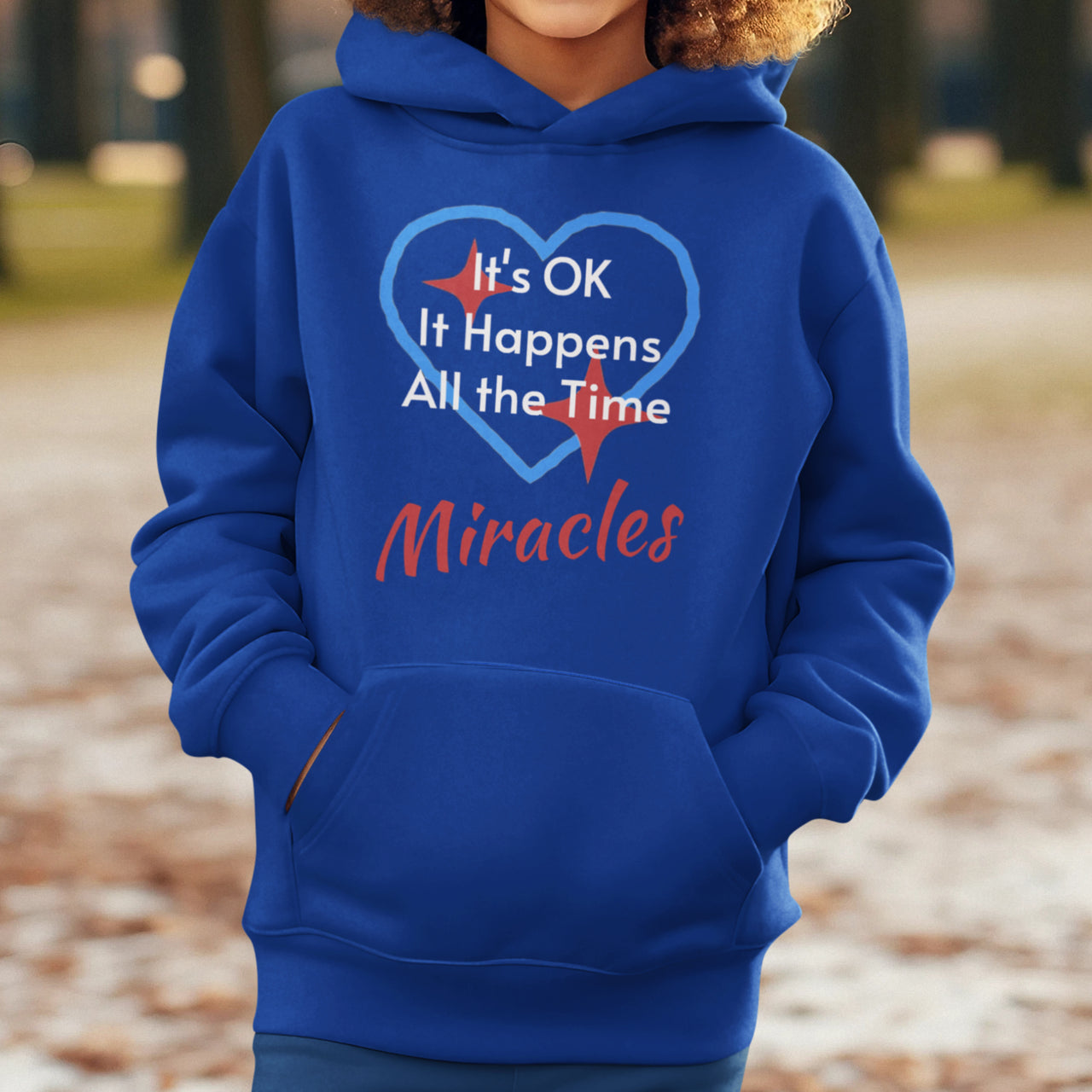 Gildan youth unisex hoodie with “Miracles Happen” design and uplifting message, Christian apparel made from soft preshrunk fleece, ideal for cooler weather and faith-inspired comfort, boy in blue hoodie