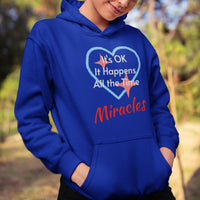 Gildan youth unisex hoodie with “Miracles Happen” design and uplifting message, Christian apparel made from soft preshrunk fleece, ideal for cooler weather and faith-inspired comfort, girl in blue hoodie