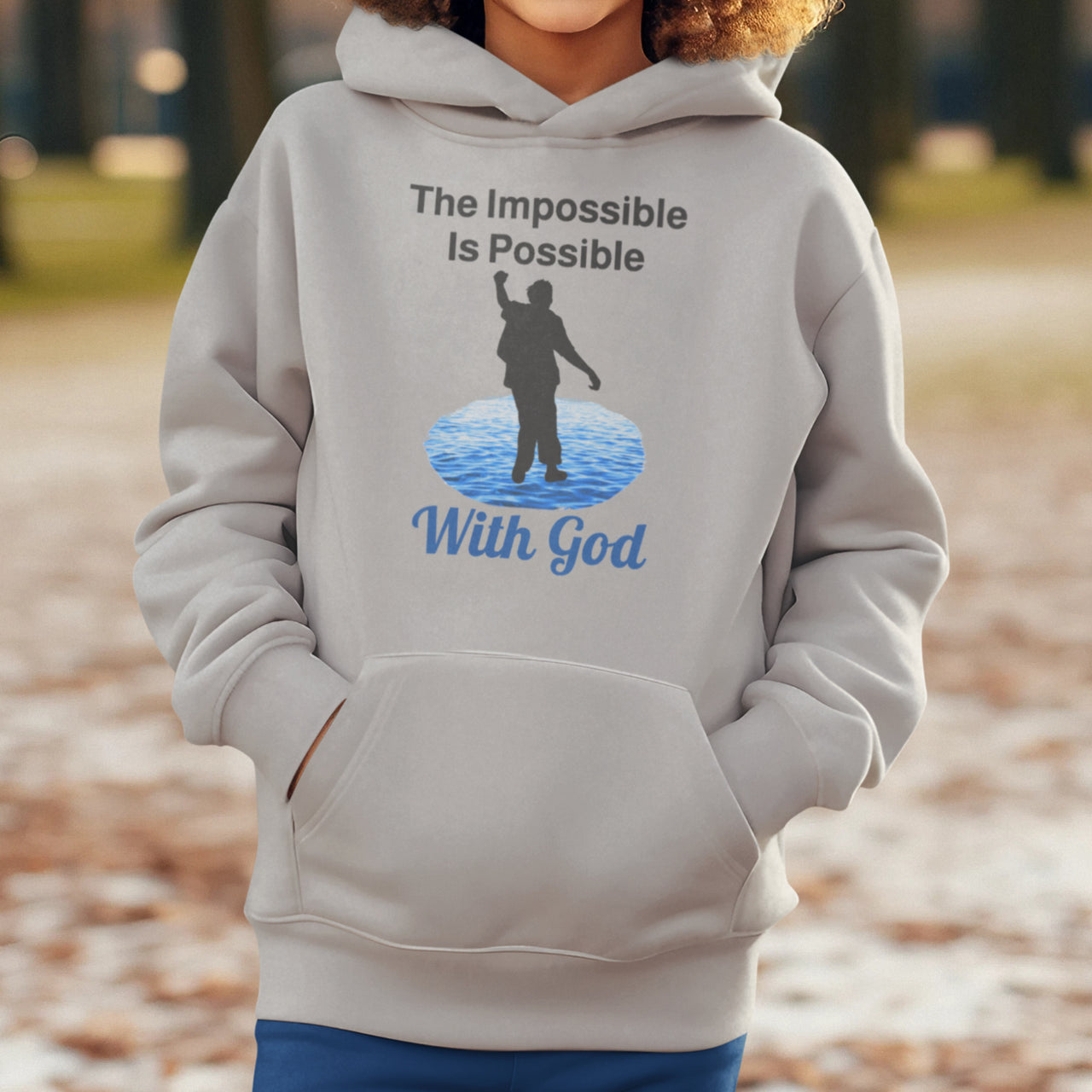 Gildan youth unisex hoodie with “Impossible Teen” design featuring a teen walking on water and uplifting message, Christian apparel made from soft preshrunk fleece, perfect for cold weather and spiritual encouragement, boy in gray hoodie