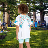 Girls’ butterfly sports jersey with colorful flower design and “I love you” message, moisture-wicking polyester, part of Paisley’s Corner Collection, ideal for school and active wear, girl in butterfly garden top - back view