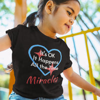 Bella+Canvas toddler t-shirt with “Miracles Happen” design and uplifting message, soft cotton, breathable and durable, Christian apparel for everyday wear and family matching, toddler girl in black t-shirt