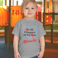 Bella+Canvas toddler t-shirt with “Miracles Happen” design and uplifting message, soft cotton, breathable and durable, Christian apparel for everyday wear and family matching, toddler boy in gray t-shirt