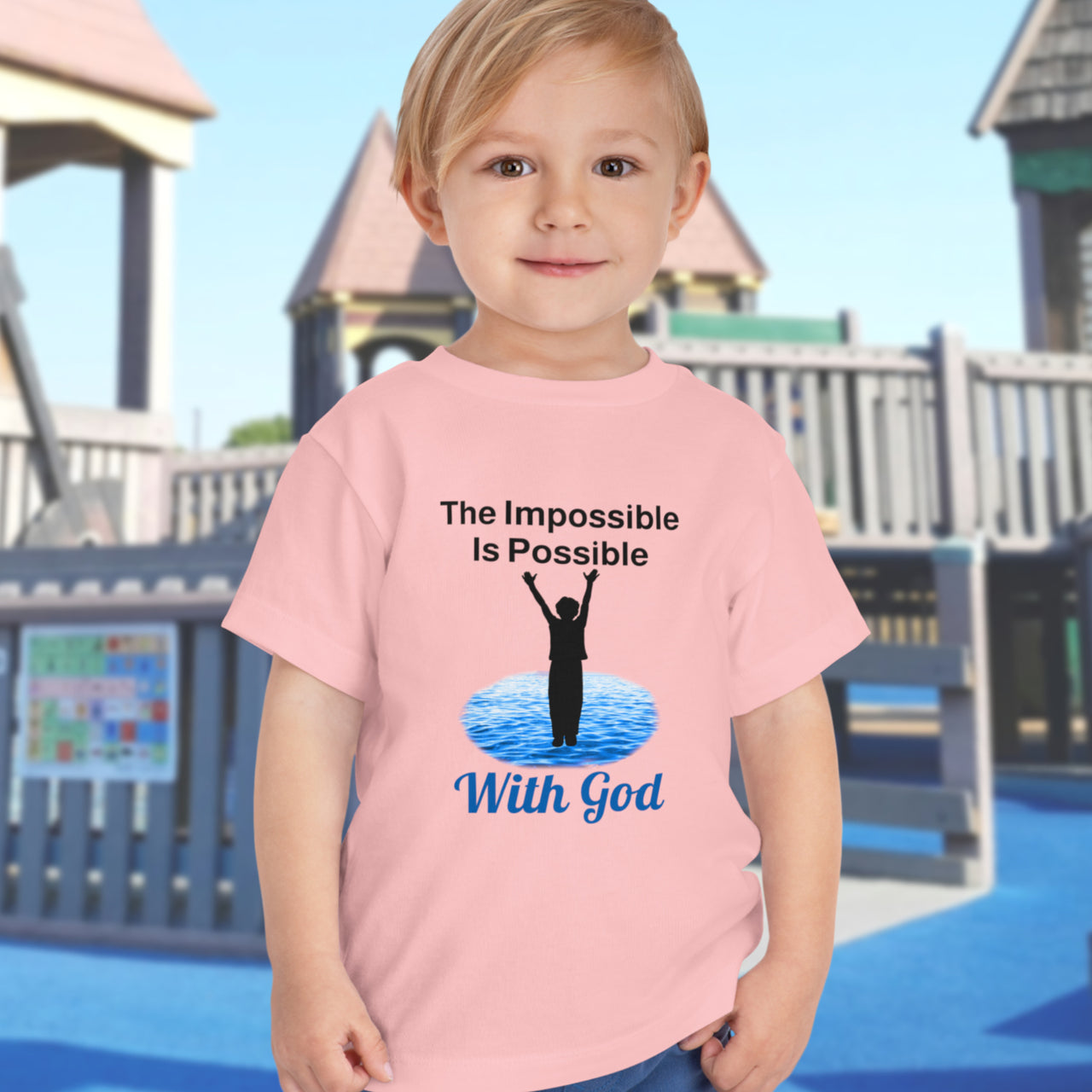 Bella+Canvas toddler t-shirt with “Impossible Toddler” design and faith-filled message, soft cotton, breathable and durable, Christian apparel for active toddlers and family matching, toddler boy in pink t-shirt