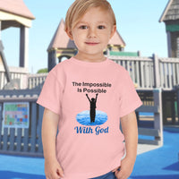 Bella+Canvas toddler t-shirt with “Impossible Toddler” design and faith-filled message, soft cotton, breathable and durable, Christian apparel for active toddlers and family matching, toddler boy in pink t-shirt