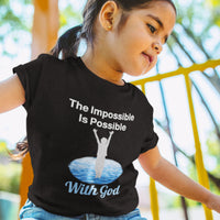 Bella+Canvas toddler t-shirt with “Impossible Toddler” design and faith-filled message, soft cotton, breathable and durable, Christian apparel for active toddlers and family matching, toddler girl in black t-shirt